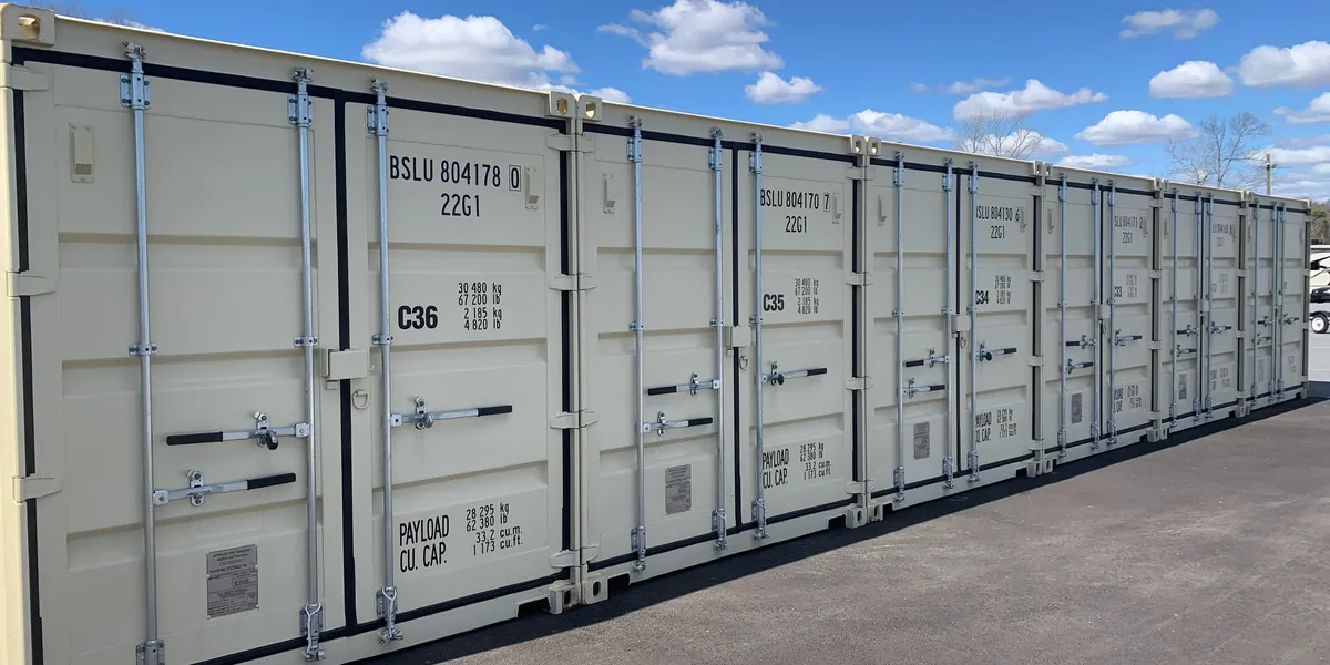 Row of tan steel shipping container storage units